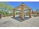 Shaded community picnic area with stone pillars and a table for neighborhood gatherings and casual dining at 18609 W Diana Ave, Waddell, AZ 85355