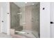 Tiled glass walk-in shower with a built-in seat and modern fixtures at 18609 W Diana Ave, Waddell, AZ 85355