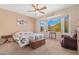 Comfortable bedroom with bay windows, a ceiling fan, and bright decor at 18668 N Lariat Ct, Surprise, AZ 85387