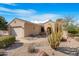 Charming single-story home with desert landscaping and an arched entryway at 18668 N Lariat Ct, Surprise, AZ 85387