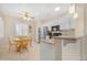 Charming eat-in kitchen featuring white cabinets and a stainless steel refrigerator at 18668 N Lariat Ct, Surprise, AZ 85387