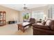 Inviting living room featuring tile floors, ceiling fan, and sliding door access to outdoor space at 18668 N Lariat Ct, Surprise, AZ 85387