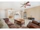 Inviting living room with tile floors and an open layout into the eat-in kitchen at 18668 N Lariat Ct, Surprise, AZ 85387