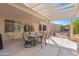 Covered patio featuring an outdoor dining table and chairs, as well as a fire pit at 18668 N Lariat Ct, Surprise, AZ 85387