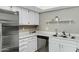 Close-up of a bright kitchen featuring white cabinets and stainless steel appliances and skylight at 1930 S Westwood Dr # 29, Mesa, AZ 85210