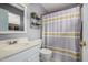 Bright bathroom featuring a large mirror, white vanity, and a shower with a stylish curtain at 1973 E Buena Vista Dr, Chandler, AZ 85249