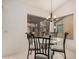 Bright dining area featuring a glass-top table, stylish chandelier, and a window with outdoor views at 1973 E Buena Vista Dr, Chandler, AZ 85249