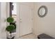 Clean entryway with a white door, tiled floor, and natural light from a side window at 1973 E Buena Vista Dr, Chandler, AZ 85249