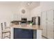 Modern kitchen with stainless steel appliances, granite counters, white cabinets, and a breakfast bar at 1973 E Buena Vista Dr, Chandler, AZ 85249