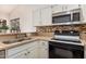 Kitchen featuring stainless steel appliances, granite countertops, and white cabinets at 1973 E Buena Vista Dr, Chandler, AZ 85249