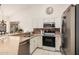 Well-lit kitchen featuring stainless steel appliances, granite countertops, and white cabinetry at 1973 E Buena Vista Dr, Chandler, AZ 85249