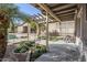 Backyard patio area featuring a pergola, lush landscaping, and serene outdoor space at 20187 E Sonoqui Blvd, Queen Creek, AZ 85142