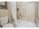 Cozy bathroom showcasing a tiled bathtub with a shower curtain and convenient grab bar at 20187 E Sonoqui Blvd, Queen Creek, AZ 85142