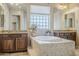 Bathroom features a large soaking tub with tile surround, dual vanities, and neutral decor at 20187 E Sonoqui Blvd, Queen Creek, AZ 85142