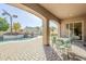 Inviting covered patio with an outdoor dining area overlooking a sparkling pool and lush landscaping at 20187 E Sonoqui Blvd, Queen Creek, AZ 85142