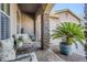 Comfortable covered patio with stone pillars, a cushioned seating area, and garden views at 20187 E Sonoqui Blvd, Queen Creek, AZ 85142