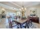 Spacious dining area featuring a grand chandelier, and views into the living room at 20187 E Sonoqui Blvd, Queen Creek, AZ 85142