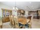 Dining room with a wooden table, china cabinet, chandelier, and a view into the kitchen at 20187 E Sonoqui Blvd, Queen Creek, AZ 85142