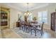 Formal dining room showcasing chandelier, plantation shutters, and a large dining table at 20187 E Sonoqui Blvd, Queen Creek, AZ 85142