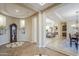 Open and airy foyer with hardwood-style floors leads to other living spaces at 20187 E Sonoqui Blvd, Queen Creek, AZ 85142