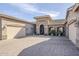 A welcoming driveway leads to a courtyard at the entry to this attractive home with stone and stucco at 20187 E Sonoqui Blvd, Queen Creek, AZ 85142