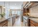 Kitchen with stainless steel appliances, stone backsplash, a long island, and an adjacent dining area at 20187 E Sonoqui Blvd, Queen Creek, AZ 85142