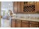 Gourmet kitchen featuring custom cabinets, granite counters, and a decorative tile backsplash at 20187 E Sonoqui Blvd, Queen Creek, AZ 85142