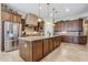 Spacious kitchen with a large center island, stainless steel appliances, and custom cabinets at 20187 E Sonoqui Blvd, Queen Creek, AZ 85142