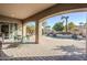 Covered patio with seating area overlooking a beautiful pool and landscaped backyard at 20187 E Sonoqui Blvd, Queen Creek, AZ 85142