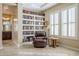 Cozy sitting area with bookshelves, a comfortable armchair, and bright natural light at 20187 E Sonoqui Blvd, Queen Creek, AZ 85142