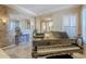 Bright sitting room offering a grand piano and hardwood-style tiled floors at 20187 E Sonoqui Blvd, Queen Creek, AZ 85142