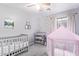 Bedroom with a crib, changing table, and canopy at 2021 S 84Th Ave, Tolleson, AZ 85353