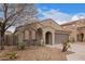 Attractive home with a tile roof, arched entryway, two-car garage, and low-maintenance desert landscaping at 2021 S 84Th Ave, Tolleson, AZ 85353