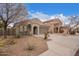 Charming exterior features desert landscaping, a tile roof, and a welcoming front entry with a covered porch at 2021 S 84Th Ave, Tolleson, AZ 85353