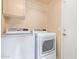 Laundry room featuring a front-loading washer and dryer and a shelf above at 2021 S 84Th Ave, Tolleson, AZ 85353