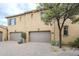 Charming exterior featuring a three car garage, desert landscaping, and traditional design at 20704 N 90Th Pl # 1065, Scottsdale, AZ 85255