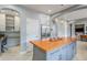 This open kitchen features an orange island countertop and stainless steel refrigerator at 20704 N 90Th Pl # 1065, Scottsdale, AZ 85255