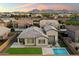 Stunning aerial view of home featuring a backyard pool and lush green lawn with mountain views at 20954 E Camacho Ct, Queen Creek, AZ 85142