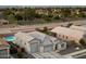Beautiful aerial view showcases a home with a spacious three car garage, pool, and green space at 20954 E Camacho Ct, Queen Creek, AZ 85142