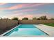Serene pool with surrounding landscape provides a peaceful retreat in this private backyard setting at 20954 E Camacho Ct, Queen Creek, AZ 85142