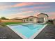 Relaxing backyard features a sparkling pool and a cozy seating area, perfect for outdoor enjoyment at 20954 E Camacho Ct, Queen Creek, AZ 85142