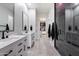 Modern bathroom features double sinks, sleek fixtures, and a glass-enclosed shower at 20954 E Camacho Ct, Queen Creek, AZ 85142