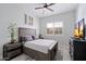 Cozy bedroom with a full-size bed, neutral walls, and natural light from a large window at 20954 E Camacho Ct, Queen Creek, AZ 85142