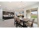 Open concept dining area features contemporary lighting and seamlessly connects to the kitchen and living room at 20954 E Camacho Ct, Queen Creek, AZ 85142