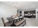 Dining room showcases a dark wood table, upholstered chairs and bench seating, with modern lighting fixtures at 20954 E Camacho Ct, Queen Creek, AZ 85142