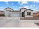 Charming single-story home boasts a three-car garage, manicured landscaping, and inviting curb appeal at 20954 E Camacho Ct, Queen Creek, AZ 85142