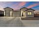 Attractive home exterior featuring a three-car garage, neutral stucco, and well-manicured landscaping at 20954 E Camacho Ct, Queen Creek, AZ 85142