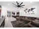 Bright and airy living room open to kitchen features a sectional sofa and modern decor at 20954 E Camacho Ct, Queen Creek, AZ 85142