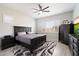 Inviting main bedroom with dark wood furnishings, ceiling fan, and a neutral color palette at 20954 E Camacho Ct, Queen Creek, AZ 85142