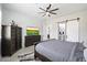 Comfortable main bedroom with dark wood furnishings, ceiling fan, and ensuite bathroom access at 20954 E Camacho Ct, Queen Creek, AZ 85142